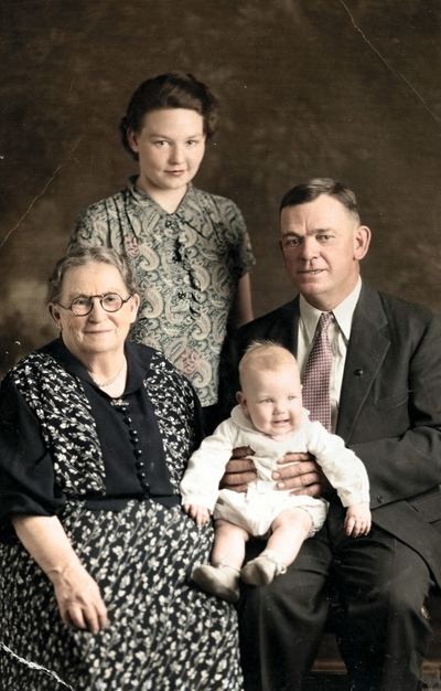 Restored and colorized (AI-assisted); faces are the original photo, colours are a best guess. Iona Belle Brock Bowles with younger family and an infant — uploader caption names Iona Belle Brock, Yolanda Bowles and Solomon Alf.