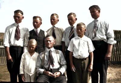 Restored and colorized (AI-assisted); faces are the original photo, colours are a best guess. William Anderson Bowles seated with his sons.