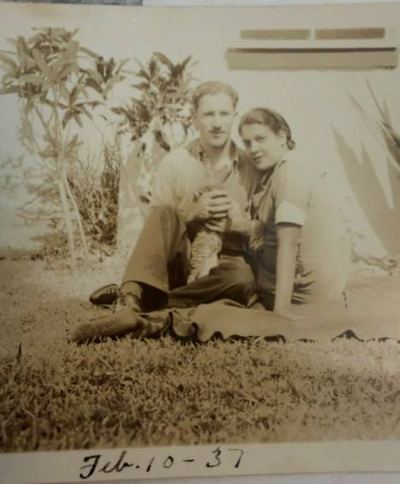 William Harry Proeger and Aileane (Da Silva) Proeger on the grass with a cat, 10 February 1937 — from the Patricia Collins collection