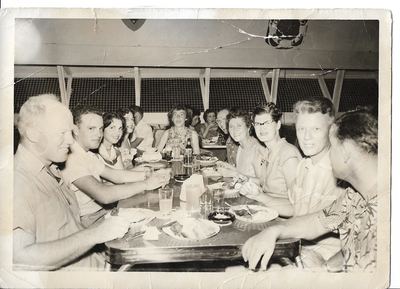 Family group at a restaurant table, c. 1955–60